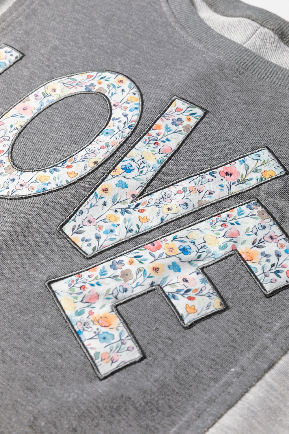 LOVE Graphic Exposed Seam Patchwork Uneven Hem Polished Sweatshirt