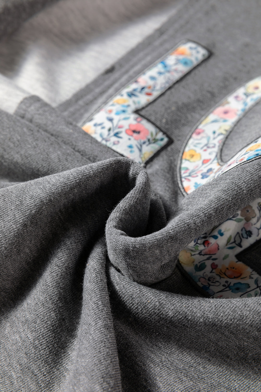 LOVE Graphic Exposed Seam Patchwork Uneven Hem Polished Sweatshirt