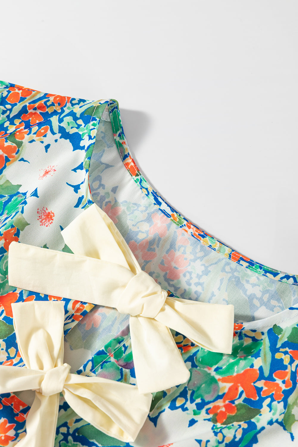 Bow Applique Floral-Print Applique Slit Sleeveless Peplum Blouse