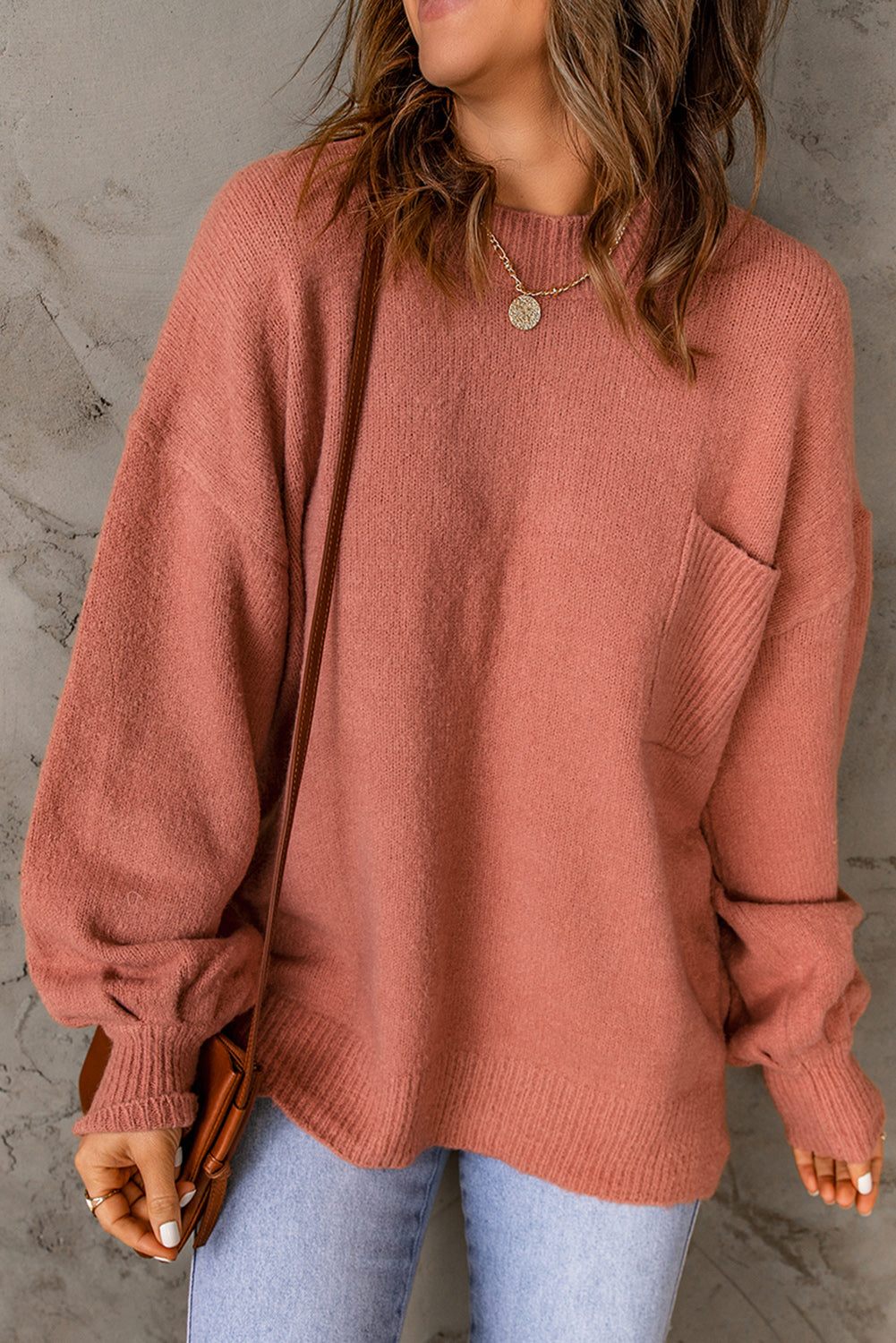 Pull avec poche à manches bouffantes de couleur unie