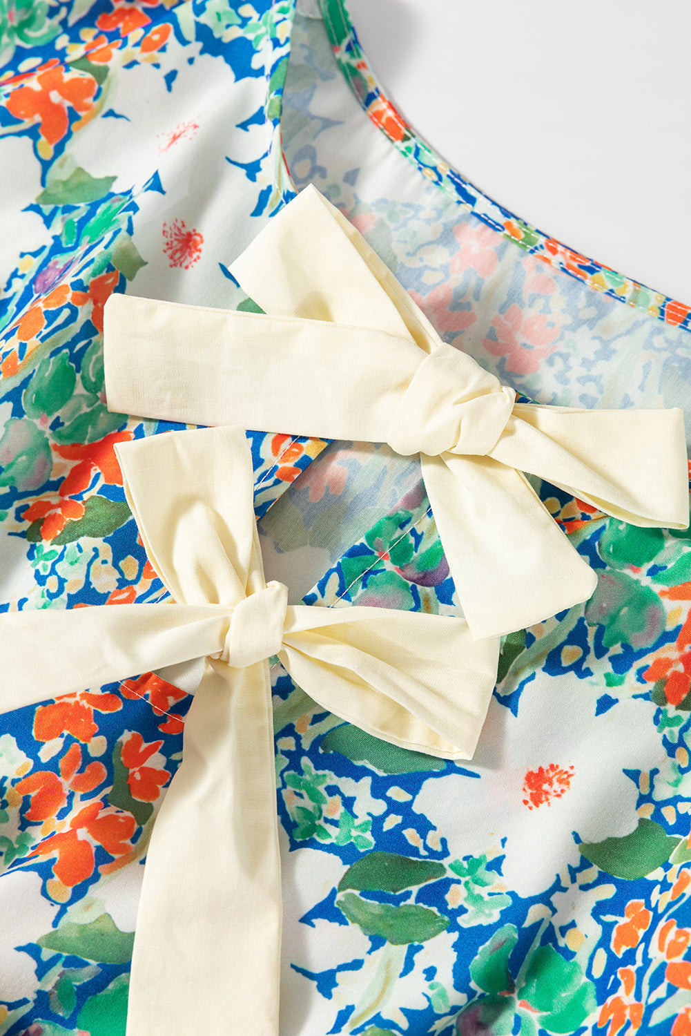 Bow Applique Floral-Print Applique Slit Sleeveless Peplum Blouse