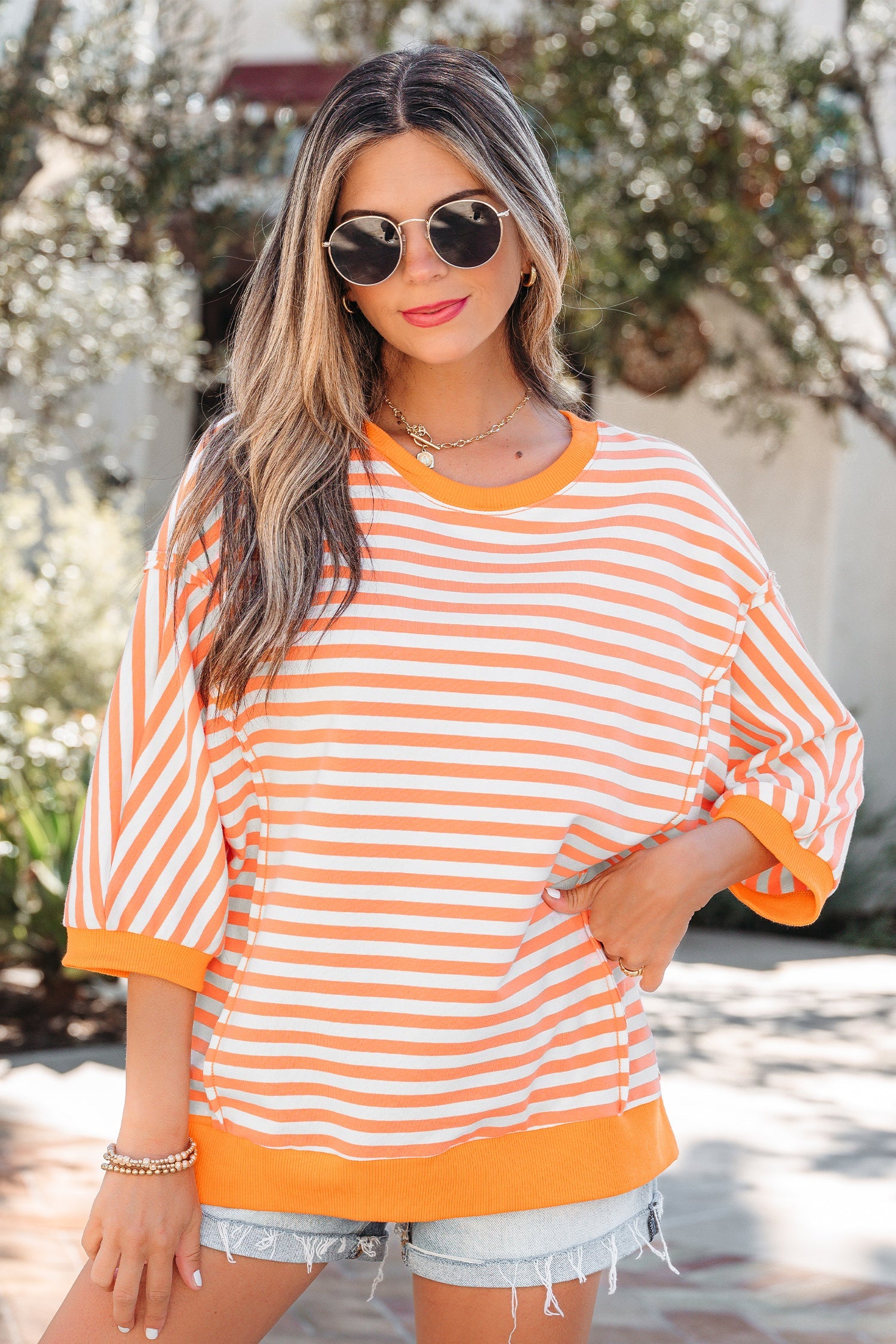 3/4 Sleeve Stripe Sleeve Exposed Seam Pullover Top in Orange