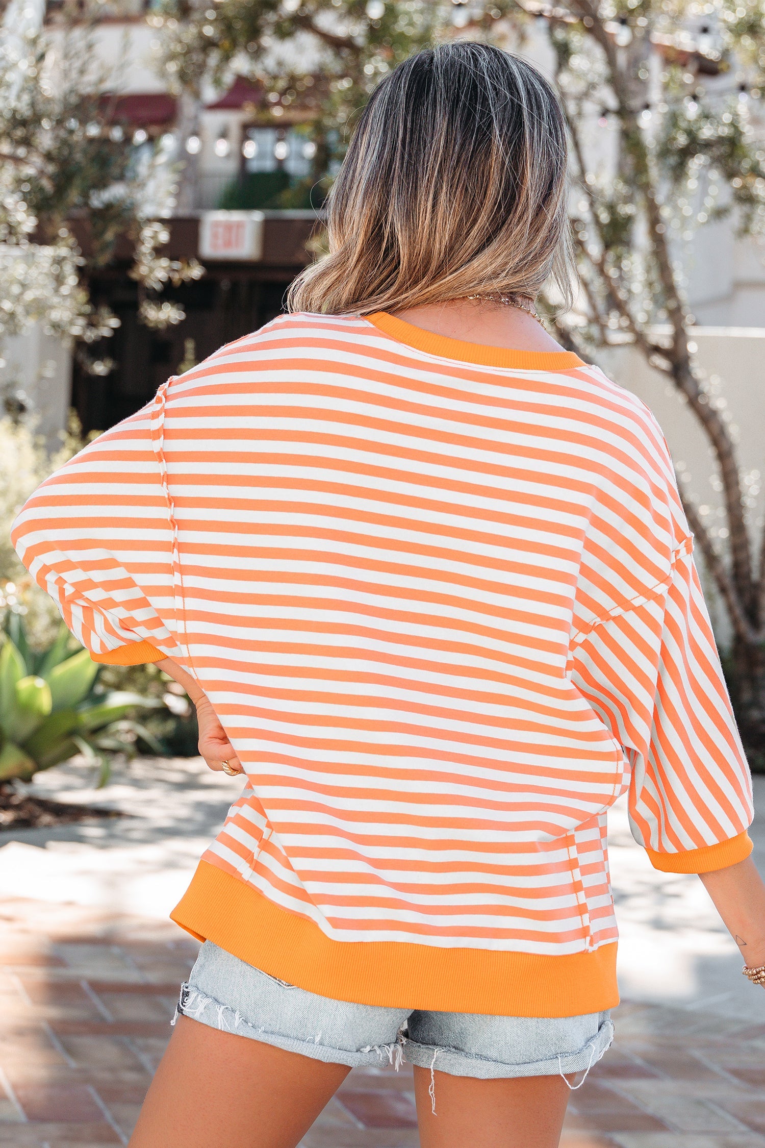 3/4 Sleeve Stripe Sleeve Exposed Seam Pullover Top in Orange